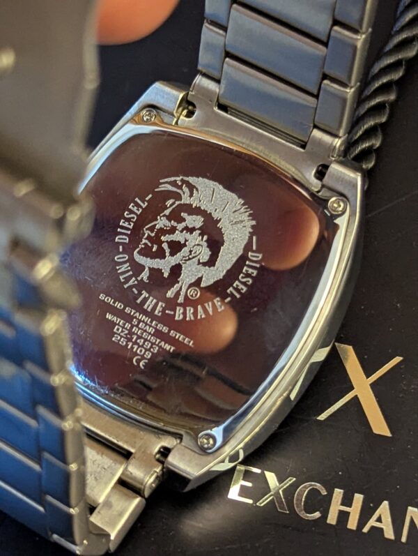 Diesel DZ1493,  Diesel "Scalped". A distinctive square, silver-tone stainless steel case and a matching link bracelet.