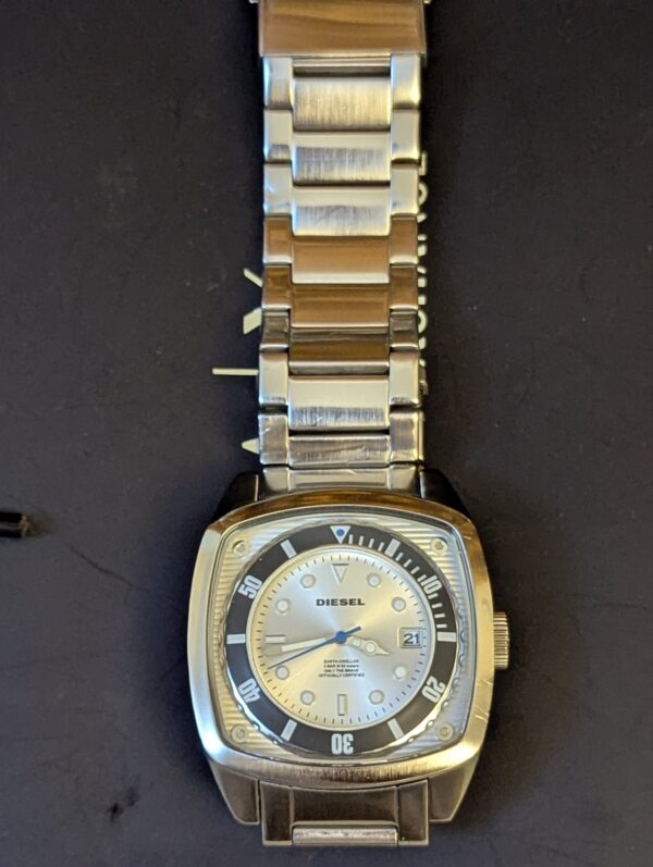 Diesel DZ1493,  Diesel "Scalped". A distinctive square, silver-tone stainless steel case and a matching link bracelet.