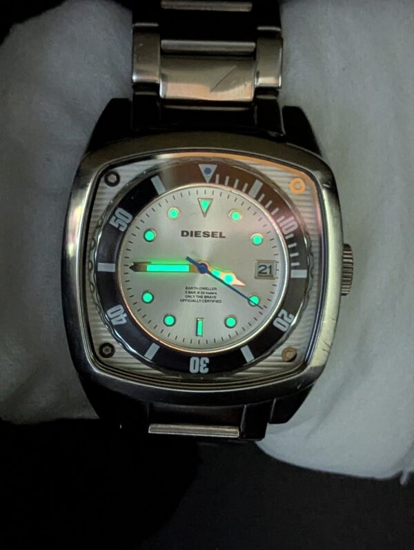 Diesel DZ1493,  Diesel "Scalped". A distinctive square, silver-tone stainless steel case and a matching link bracelet.